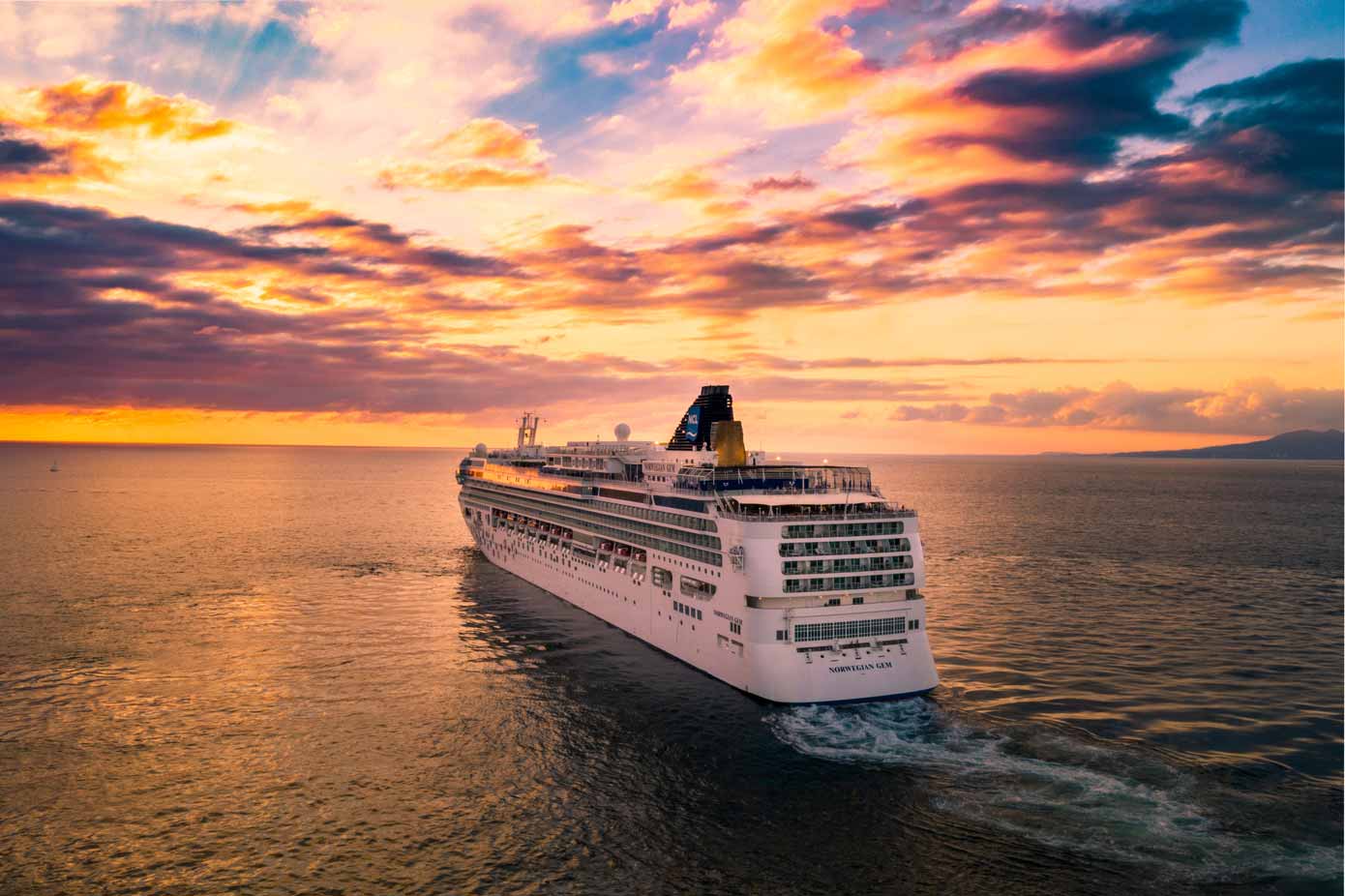 Norwegian Gem cruise ship at sunset.